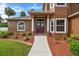 Home entrance with double red doors and landscape at 849 John Cressler Dr, Seffner, FL 33584