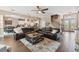 Open living room with two leather sofas, a ceiling fan, and hardwood floors at 849 John Cressler Dr, Seffner, FL 33584