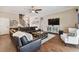 Spacious living room with hardwood floors, a large TV, and ample seating at 849 John Cressler Dr, Seffner, FL 33584