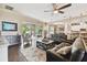 Relaxing living room featuring leather sofas, hardwood floors, and access to the backyard at 849 John Cressler Dr, Seffner, FL 33584