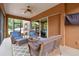 Relaxing screened porch with wicker furniture and ceiling fan at 849 John Cressler Dr, Seffner, FL 33584