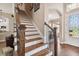 Impressive wooden staircase with wrought-iron railings at 849 John Cressler Dr, Seffner, FL 33584