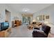 Living room with hardwood floors, neutral decor, and plenty of natural light at 428 Seneca Falls Dr, Apollo Beach, FL 33572