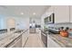 Modern kitchen with stainless steel appliances and granite countertops at 17039 Oval Rum Dr, Wimauma, FL 33598