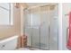 Shower with glass sliding doors and built-in shelving at 37607 Neukom Ave, Zephyrhills, FL 33541