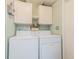 Laundry room with washer, dryer, and overhead cabinets at 37607 Neukom Ave, Zephyrhills, FL 33541