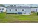 Single-wide mobile home with a small fenced backyard at 37607 Neukom Ave, Zephyrhills, FL 33541