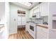 White kitchen with wood countertops and built-in microwave at 37607 Neukom Ave, Zephyrhills, FL 33541