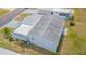 Aerial view of a home with a metal roof and screened patio at 37607 Neukom Ave, Zephyrhills, FL 33541