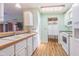 White kitchen with wood countertops and appliances at 37607 Neukom Ave, Zephyrhills, FL 33541