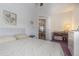 Bright bedroom with double bed, desk, and view into dining area at 37607 Neukom Ave, Zephyrhills, FL 33541