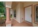 Front porch entryway with columns and a white door at 12814 Cattail Shore Ln, Riverview, FL 33579