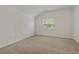 Simple bedroom with neutral walls, carpet, and a window with blinds at 12814 Cattail Shore Ln, Riverview, FL 33579