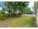 Large backyard with grassy area and wooden fence at 12814 Cattail Shore Ln, Riverview, FL 33579