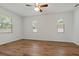 Bright bedroom with wood-look floors and ceiling fan at 12814 Cattail Shore Ln, Riverview, FL 33579