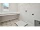 Laundry room with built-in shelving, a utility sink, and patterned flooring at 6224 Broad Field Ave, Apollo Beach, FL 33572