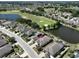 An aerial view of a home with a backyard overlooking a lush golf course and a serene lake at 1007 Emerald Dunes Dr, Sun City Center, FL 33573