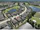 An aerial view of a house with a pool, surrounded by lush landscaping and a golf course community at 1007 Emerald Dunes Dr, Sun City Center, FL 33573