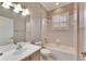 A clean bathroom with a combined tub and shower, tiled walls, and a vanity with good lighting at 1007 Emerald Dunes Dr, Sun City Center, FL 33573