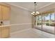 Inviting dining area features tiled floors, a modern chandelier, and direct access to the outdoor patio at 1007 Emerald Dunes Dr, Sun City Center, FL 33573