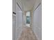 Hallway with carpet and entry to bathroom at 1007 Emerald Dunes Dr, Sun City Center, FL 33573