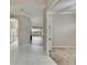 Open hallway connecting the kitchen, living room, and bedroom, offering seamless flow and access throughout the house at 1007 Emerald Dunes Dr, Sun City Center, FL 33573