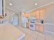 Bright kitchen featuring white appliances, tile flooring, and ample counter space for meal preparation at 1007 Emerald Dunes Dr, Sun City Center, FL 33573