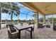 Covered lanai with views of palm trees at 1007 Emerald Dunes Dr, Sun City Center, FL 33573