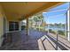 Spacious screened-in lanai with brick flooring and scenic lake views, perfect for outdoor entertaining at 1007 Emerald Dunes Dr, Sun City Center, FL 33573
