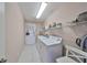 Functional laundry room features a washer, dryer, shelving, and a convenient utility sink at 1007 Emerald Dunes Dr, Sun City Center, FL 33573