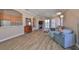 Bright and airy living room featuring wood floors, a comfortable sofa, and sliding glass doors to the outdoor space at 1007 Emerald Dunes Dr, Sun City Center, FL 33573