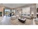 Bright living room with a sofa, dining table, rug, and large window creating an inviting space for relaxation at 1007 Emerald Dunes Dr, Sun City Center, FL 33573