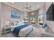 Bright main bedroom features a coastal-themed decor and large windows overlooking the manicured landscaping at 1007 Emerald Dunes Dr, Sun City Center, FL 33573