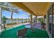 Inviting screened-in patio featuring comfortable seating and views of the tranquil lake at 1007 Emerald Dunes Dr, Sun City Center, FL 33573