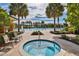 Outdoor pool and hot tub area featuring lounge chairs, landscaping, and palm trees at 1007 Emerald Dunes Dr, Sun City Center, FL 33573