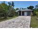 House exterior with a brick driveway and two car garage at 22491 Delhi Ave, Port Charlotte, FL 33952