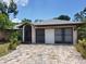House exterior with brick driveway and two-car garage at 22491 Delhi Ave, Port Charlotte, FL 33952