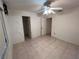 Empty bedroom with tile floor and ceiling fan at 22491 Delhi Ave, Port Charlotte, FL 33952