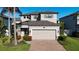 Two-story house with attached garage and brick driveway at 1953 Nature View Dr, Lutz, FL 33558