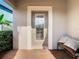 Inviting front door entry with a welcoming bench at 1953 Nature View Dr, Lutz, FL 33558