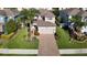 Aerial view of a house with a brick driveway at 1953 Nature View Dr, Lutz, FL 33558