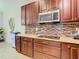 Granite countertops and dark wood cabinets in kitchen at 1953 Nature View Dr, Lutz, FL 33558
