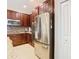 Kitchen features stainless steel refrigerator and wood cabinetry at 1953 Nature View Dr, Lutz, FL 33558