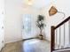 Bright and airy entryway with tile flooring and a staircase at 1953 Nature View Dr, Lutz, FL 33558