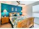 Bedroom with a teal accent wall and wood framed bed at 1953 Nature View Dr, Lutz, FL 33558