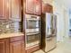 Kitchen with stainless steel appliances and dark wood cabinets at 1953 Nature View Dr, Lutz, FL 33558