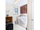 Laundry room with washer, dryer, and wooden cabinets at 1953 Nature View Dr, Lutz, FL 33558
