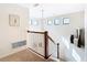 Bright upstairs hall with window lighting and railing at 1953 Nature View Dr, Lutz, FL 33558