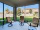 Relaxing screened patio with seating area overlooking backyard at 1953 Nature View Dr, Lutz, FL 33558