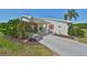 Inviting front entry with landscaping and paved driveway at 218 Glenellen Pl, Sun City Center, FL 33573
